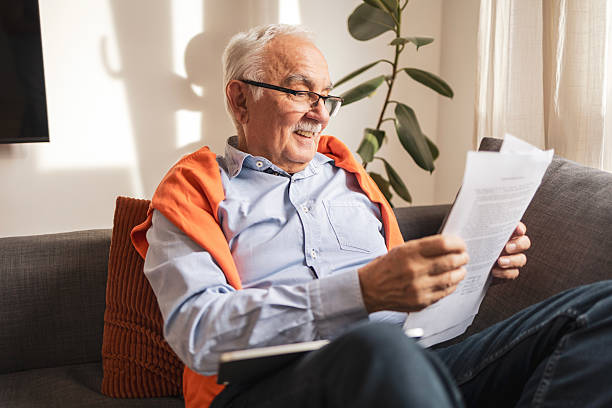 Elderly man reading a life insurance document