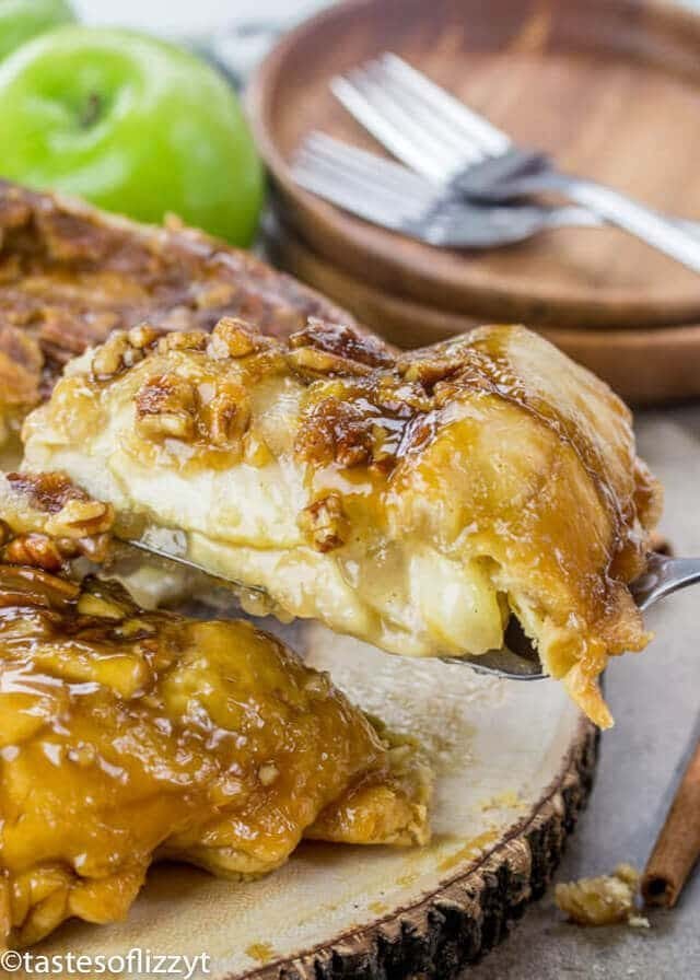 Upside Down Apple Dumpling Pie is a delicious cross between apple dumplings and apple pie! The best apple recipe for fall! A slice of upside down apple dumpling pie with brown sugar nut syrup