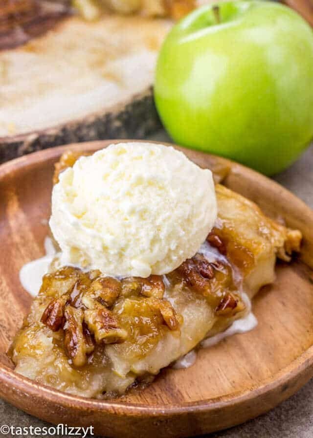 Upside Down Apple Dumpling Pie is a delicious cross between apple dumplings and apple pie! The best apple recipe for fall! Upside Down Apple Dumpling Pie topped with a scoop of vanilla ice cream