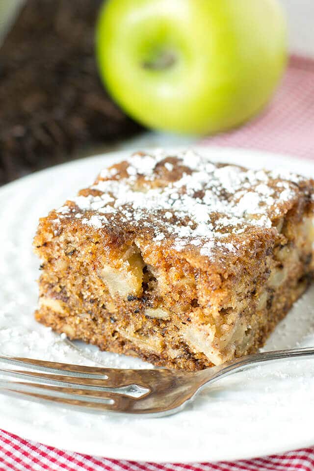 Apple Walnut Cake is a moist cake with apples and walnuts in every bite. It's one of the best apple recipes to make during the apple picking season! #dessert #cake #apples slice of apple walnut cake on a plate with a fork