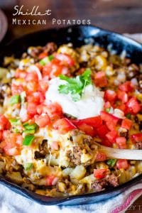 Top golden brown potatoes with your favorite taco ingredients for gluten free skillet Mexican potatoes the family will love!