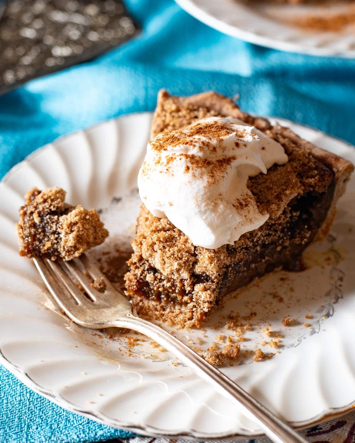 a piece of molasses pie with whipped cream on a plate