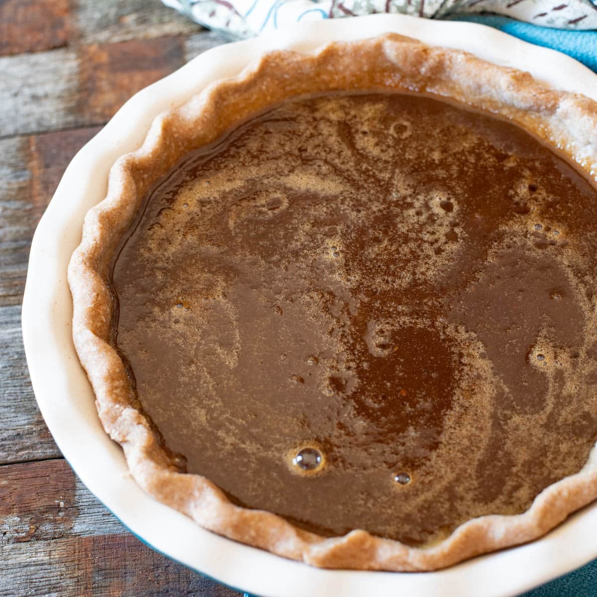 unbaked molasses pie filling in a pie shell
