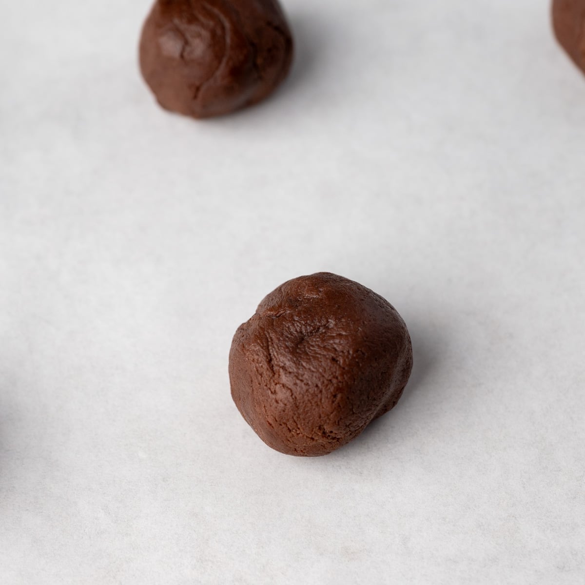 cookie dough balls on a baking sheet