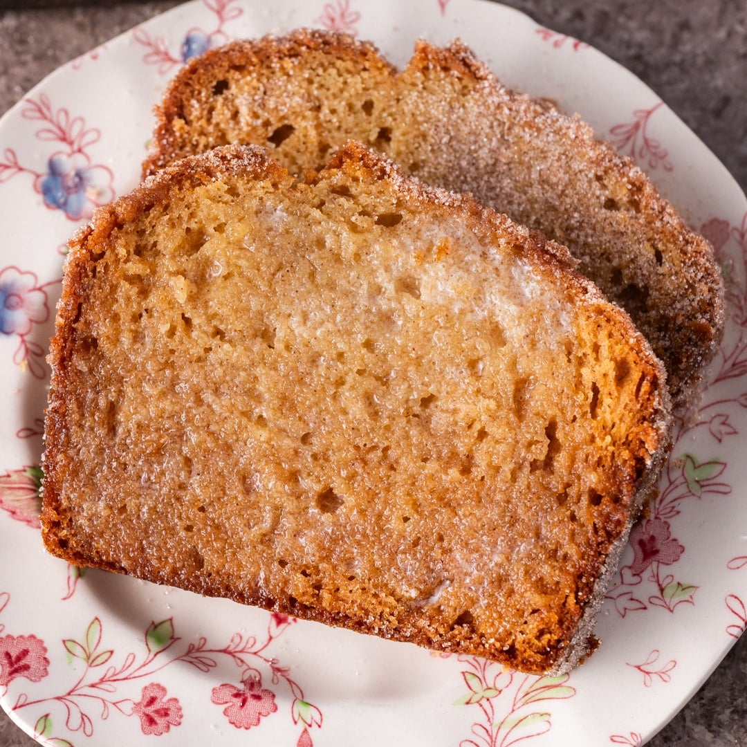 two slices of buttered amish friendship bread on a plate