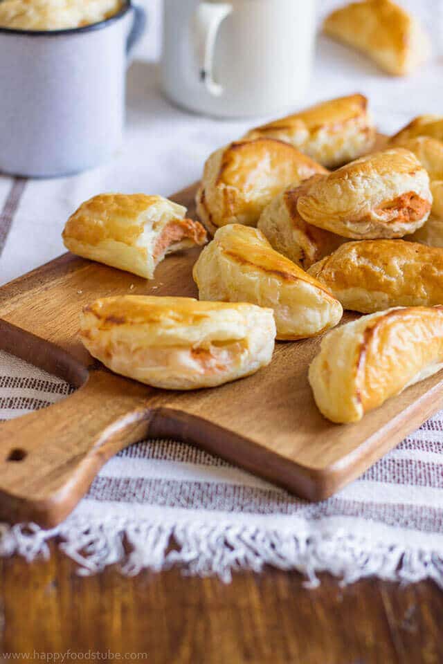 Food on a wooden table, with tuna empanadas