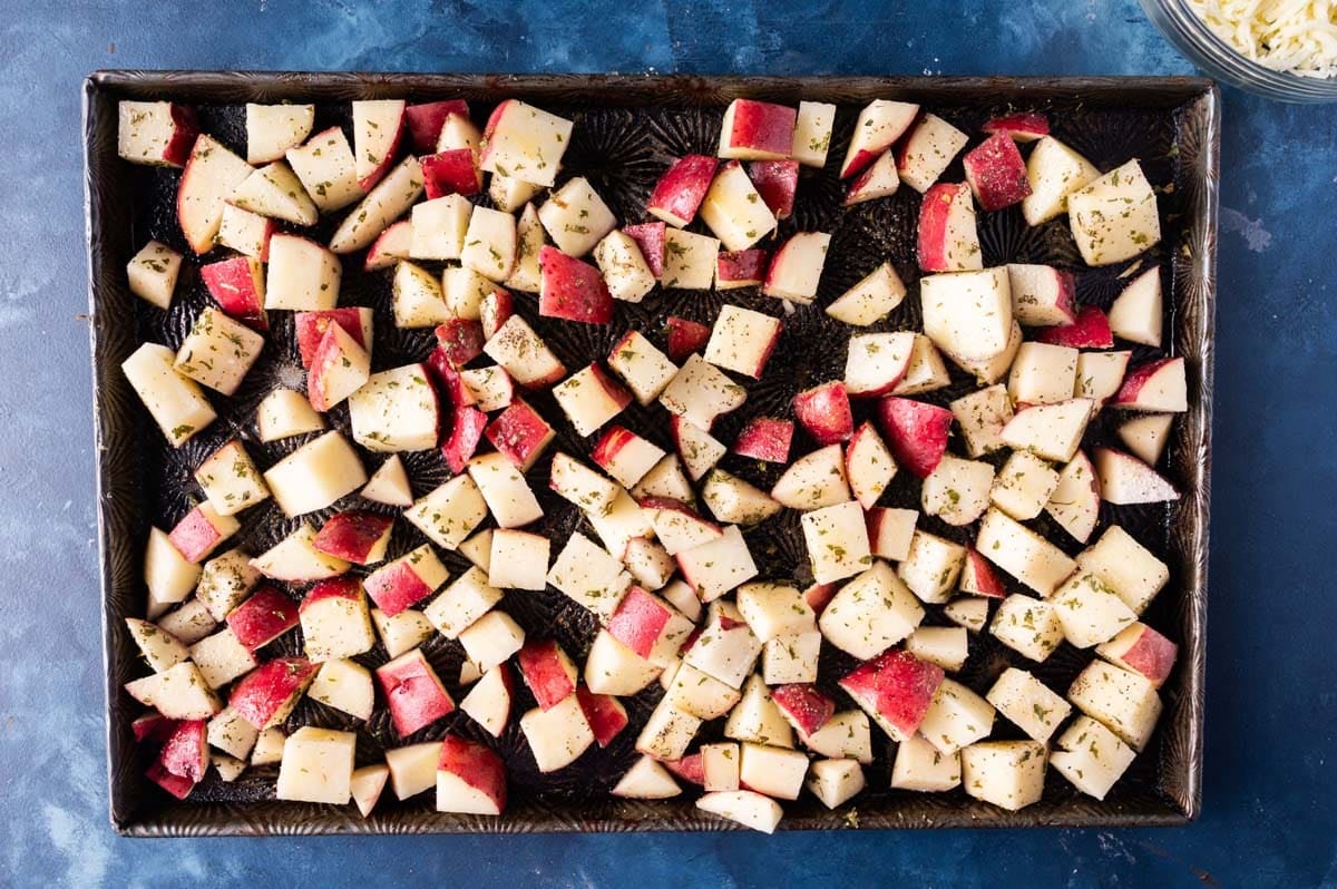 diced potatoes with seasonings on a pan