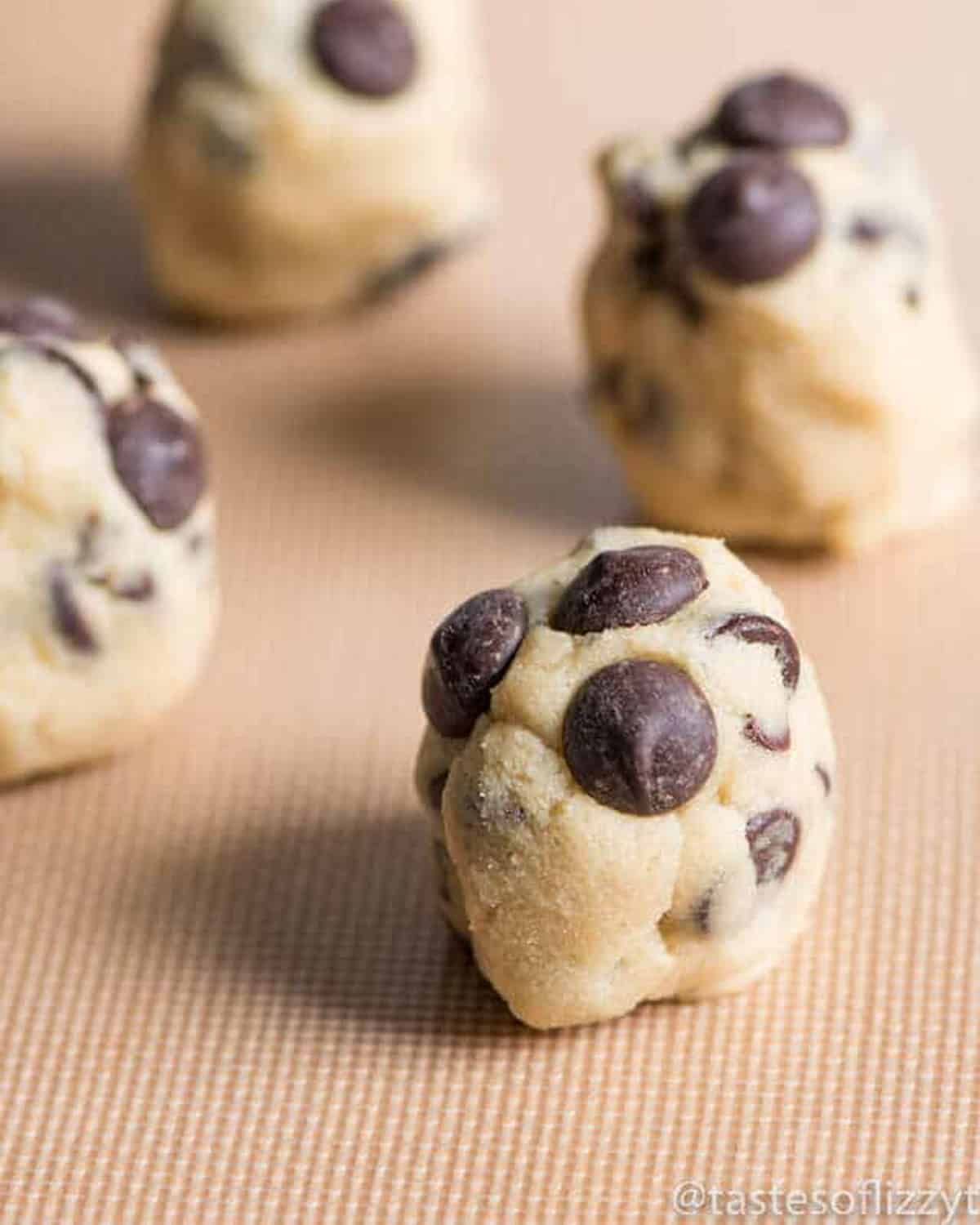 tall cookie dough balls on a nonstick sheet