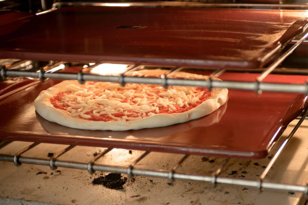 pizza in on a pizza stone in oven