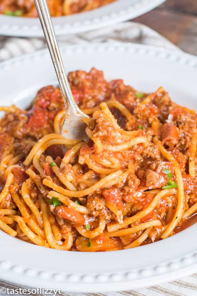 spaghetti with meat sauce on a plate with a fork
