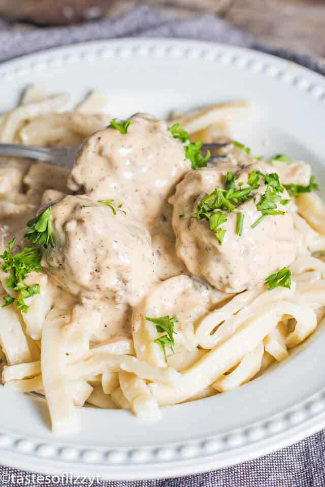 This homemade Swedish meatballs recipe will give Ikea Swedish meatballs a run for their money! The from-scratch pan gravy has a delicious creamy flavor. These are the best meatballs for a classic comfort food dinner recipe. Authentic Swedish meatballs sauce ladled over Swedish meatballs