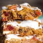 These chewy Fruit Cake Cookie Bars will melt in your mouth. This Christmas dessert with pecans, dried cherries and pineapple has a rum glaze.Â