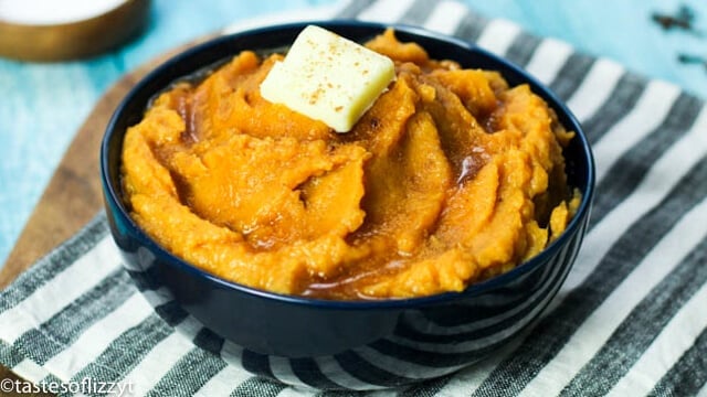bowl of mashed sweet potatoes with butter and syrup