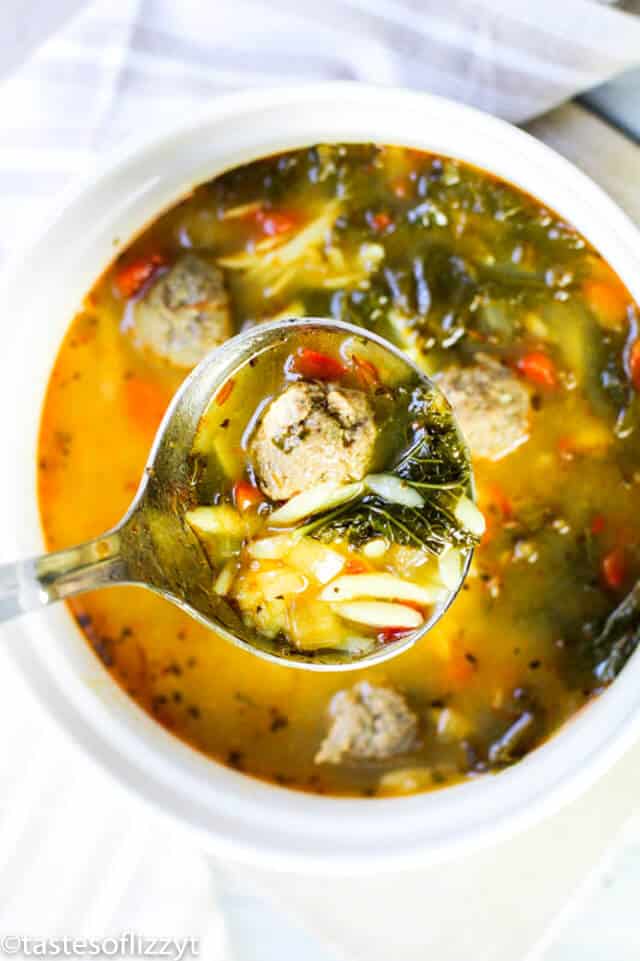 Albondigas soup is a delicious Mexican meatball soup with homemade meatballs. This traditional Mexican soup recipe makes a fantastic and easy Cinco de Mayo meal! ladle full of Mexican meatball soup with orzo pasta and baby spinach
