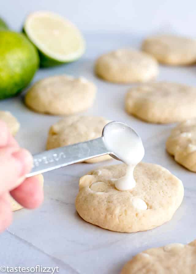 Key lime sugar cookies are soft, chewy cookies bursting with bright citrus flavor. The lime glaze on top adds even more lime flavor, making this the perfect cookie recipe for spring or summer! adding lime glaze to the top of key lime sugar cookies