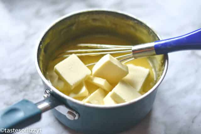 This lemon curd recipe is quick and easy to make and is so versatile! Add it to parfaits, tarts, or fruit dip. It's also perfect for breakfast, spread onto your morning toast, biscuits, or pancakes! stirring ingredients to make a lemon curd recipe