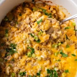 overhead view of slow cooker hamburger helper with a spoon