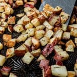 roasted red potatoes on a pan with a spatula