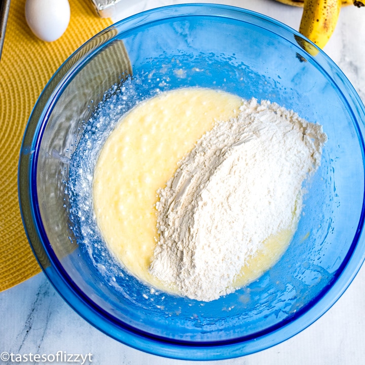 adding dry ingredients to bread batter