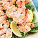 A plate of shrimp and vegetables, with Skewer