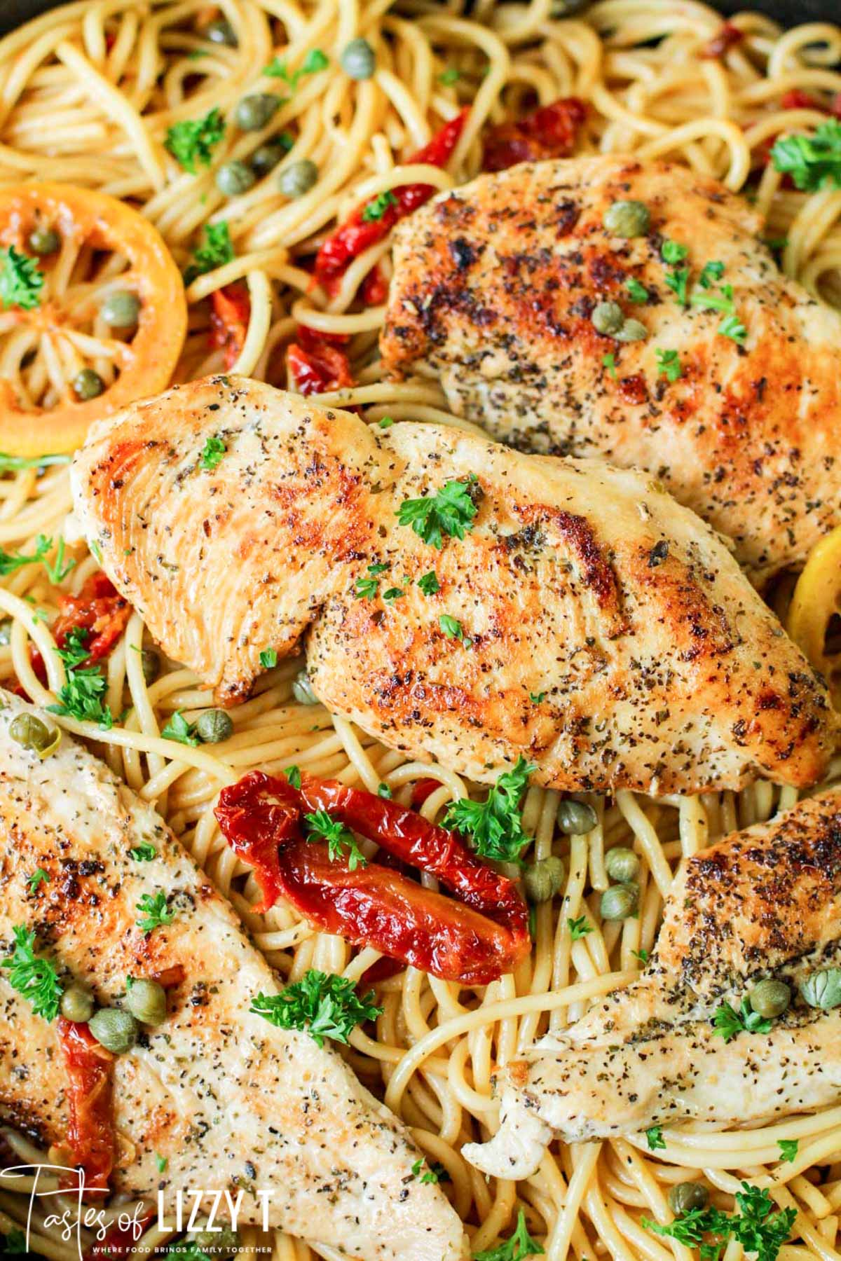 A close up of a plate of food with chicken and pasta