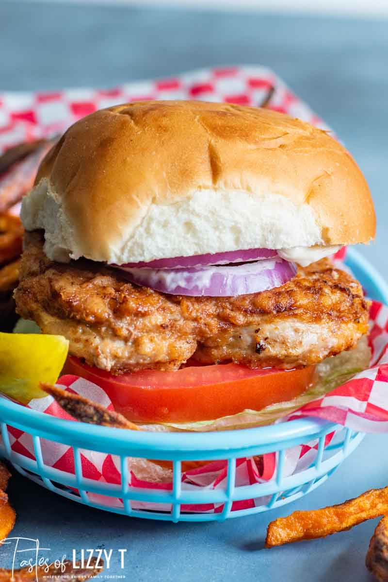 A Pork tenderloin sandwich sitting in a basket