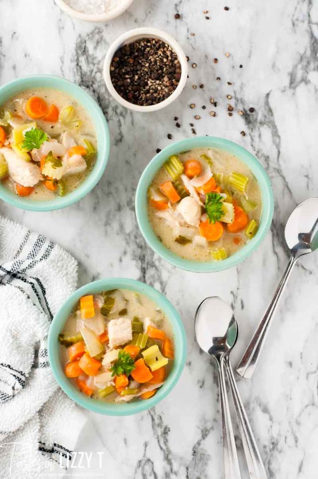 A bowl of food on a table, with Soup and Chicken