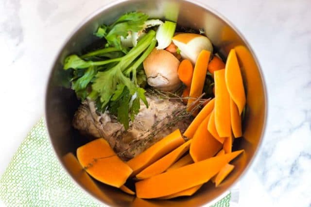 A pot of food, with vegetables and turkey