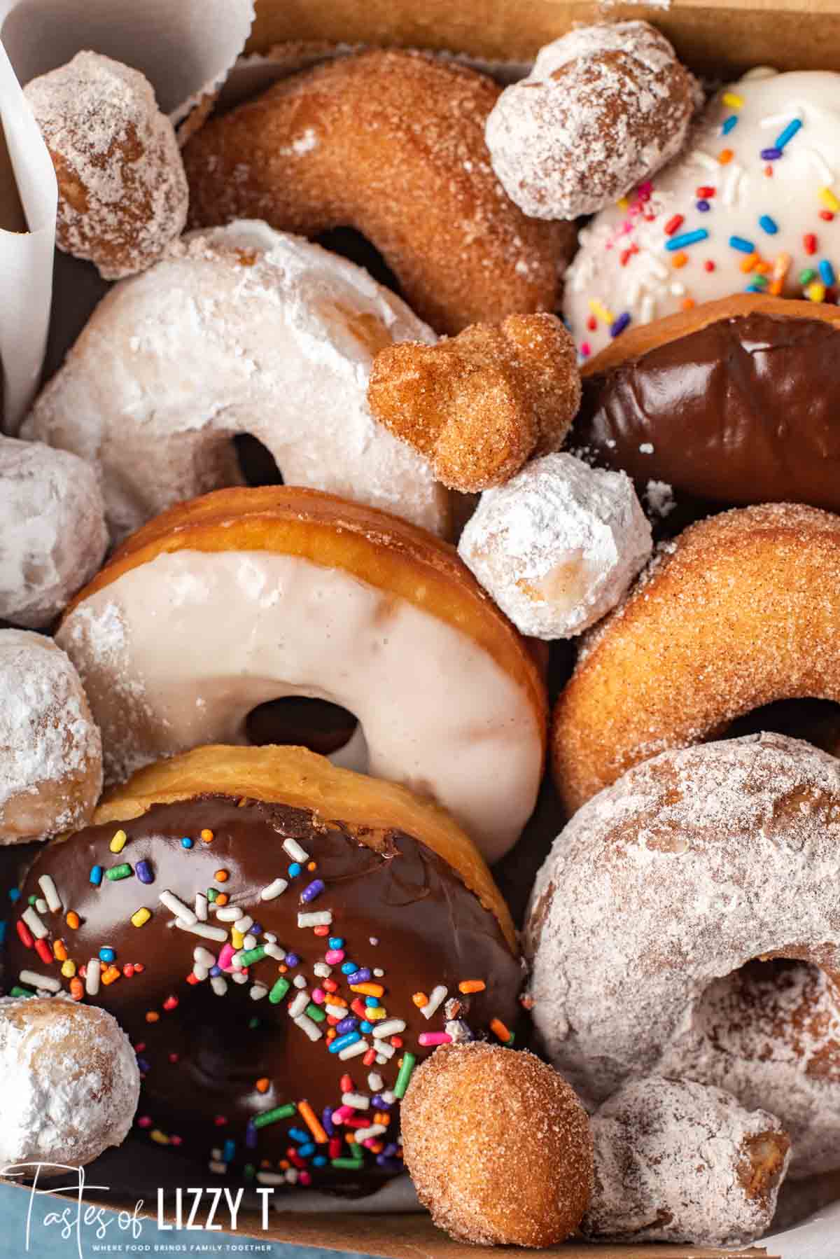 box of homemade donuts with donut holes on top