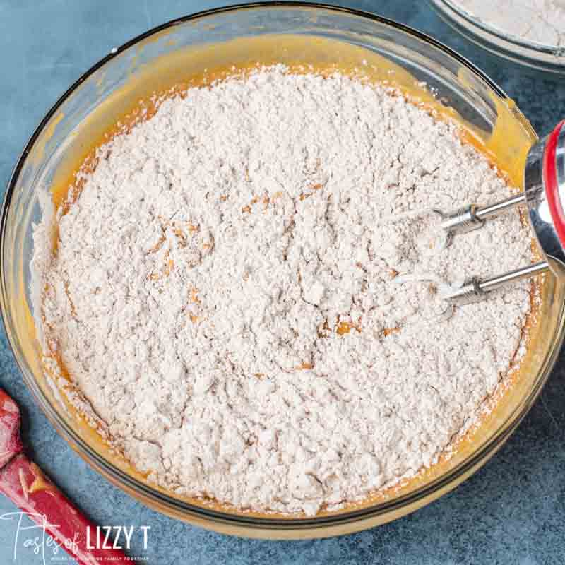 mixing flour into pumpkin bread batter
