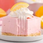 a slice of pink lemonade pie bars on a plate