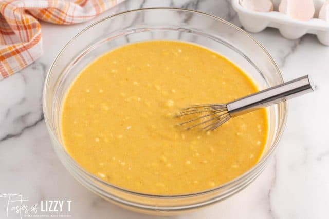 a bowl of pancake batter with a whisk