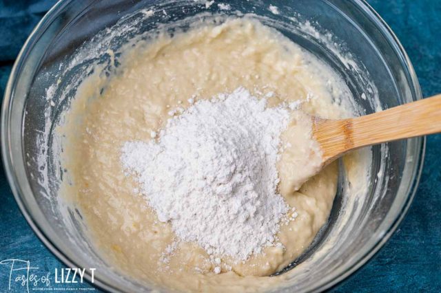 flour in wet dough in a bowl