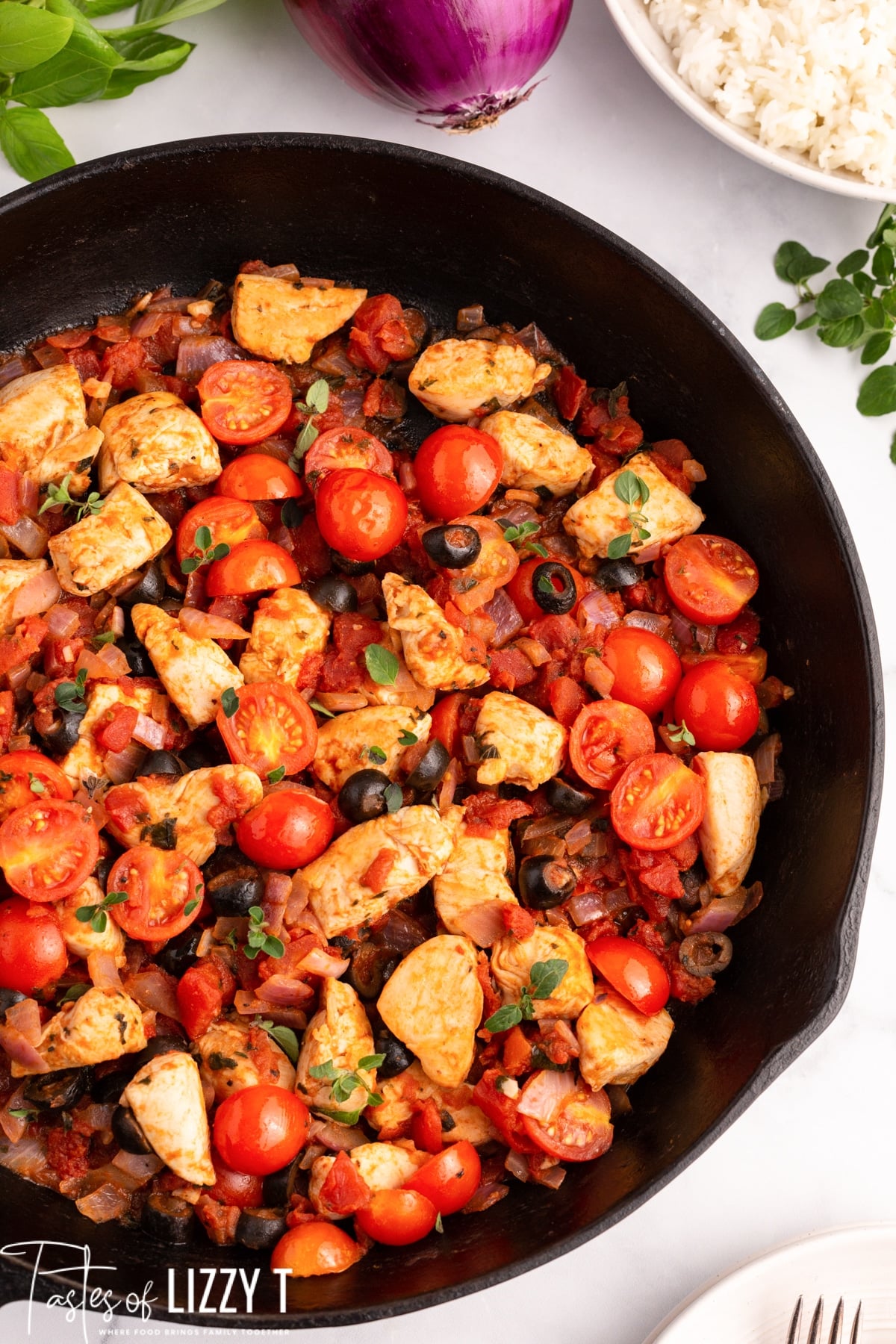 chicken and tomatoes in a skillet