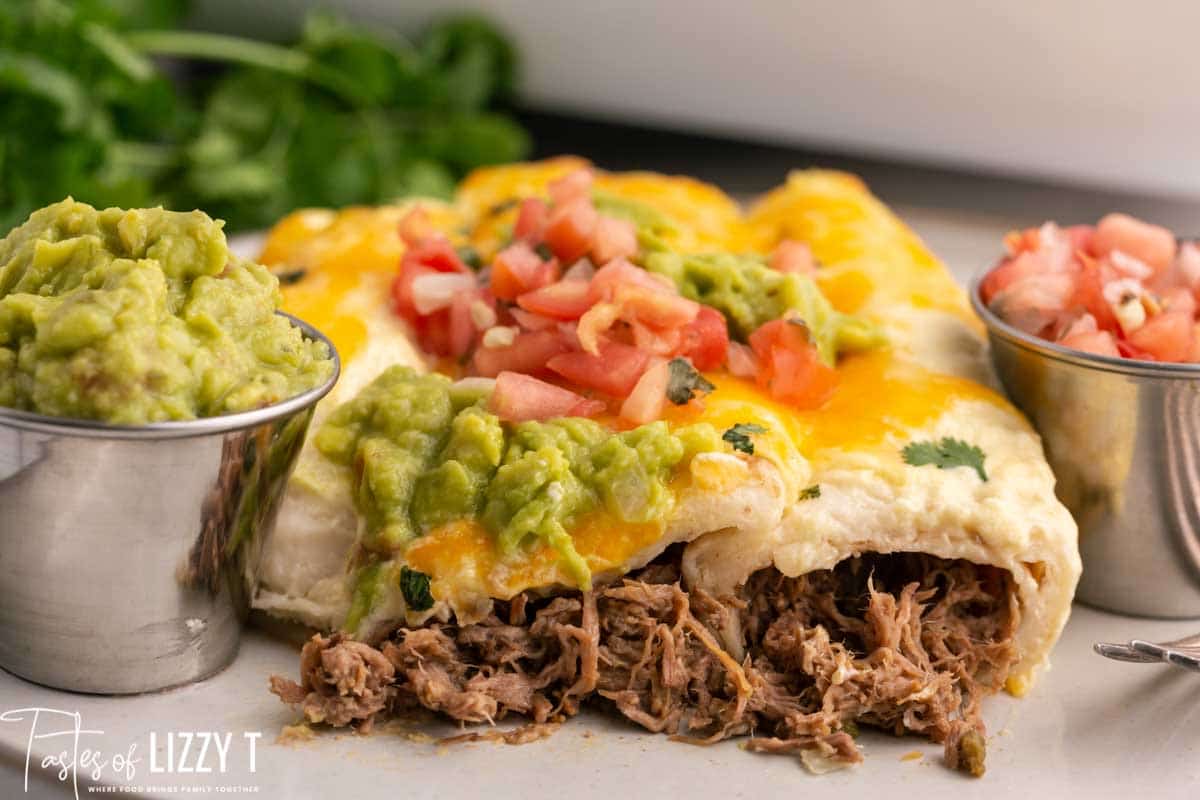 a plate of roast beef enchiladas with guacamole