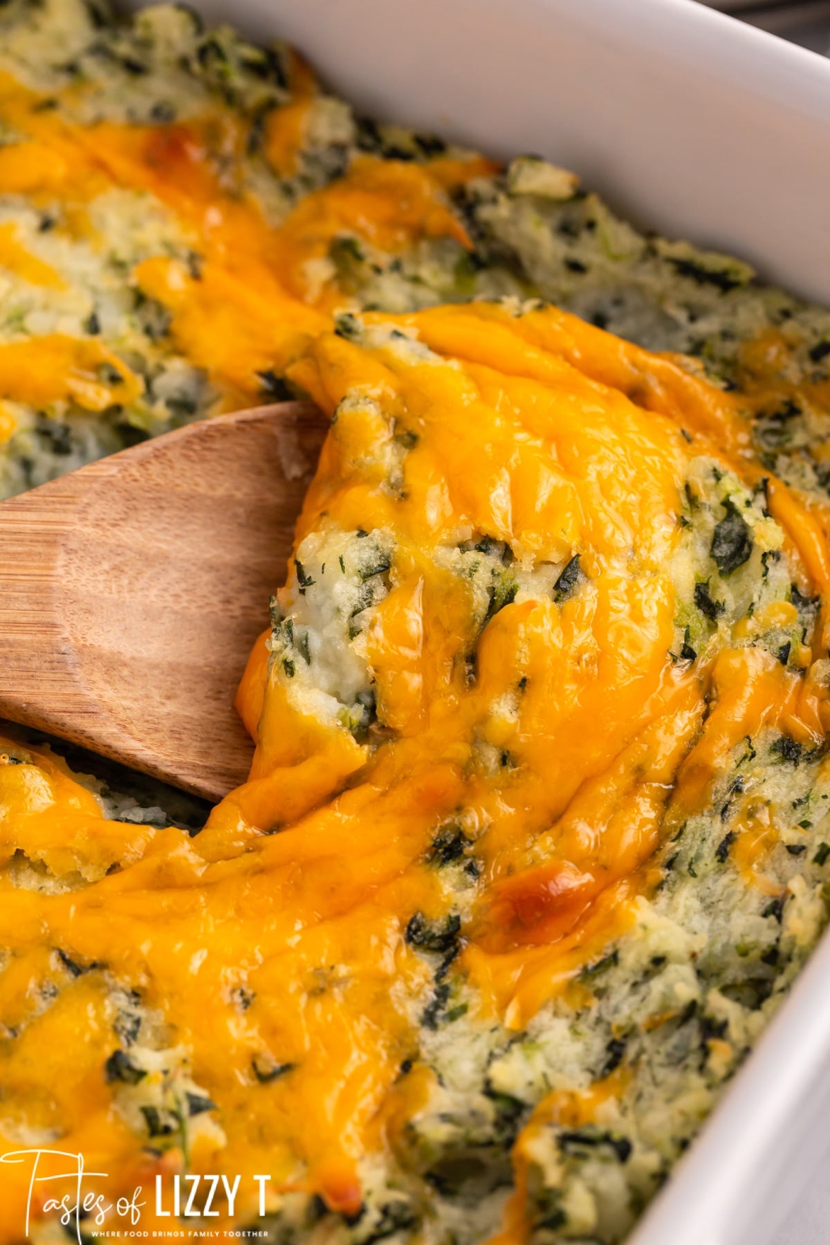 closeup of cheesy mashed potatoes in a casserole dish