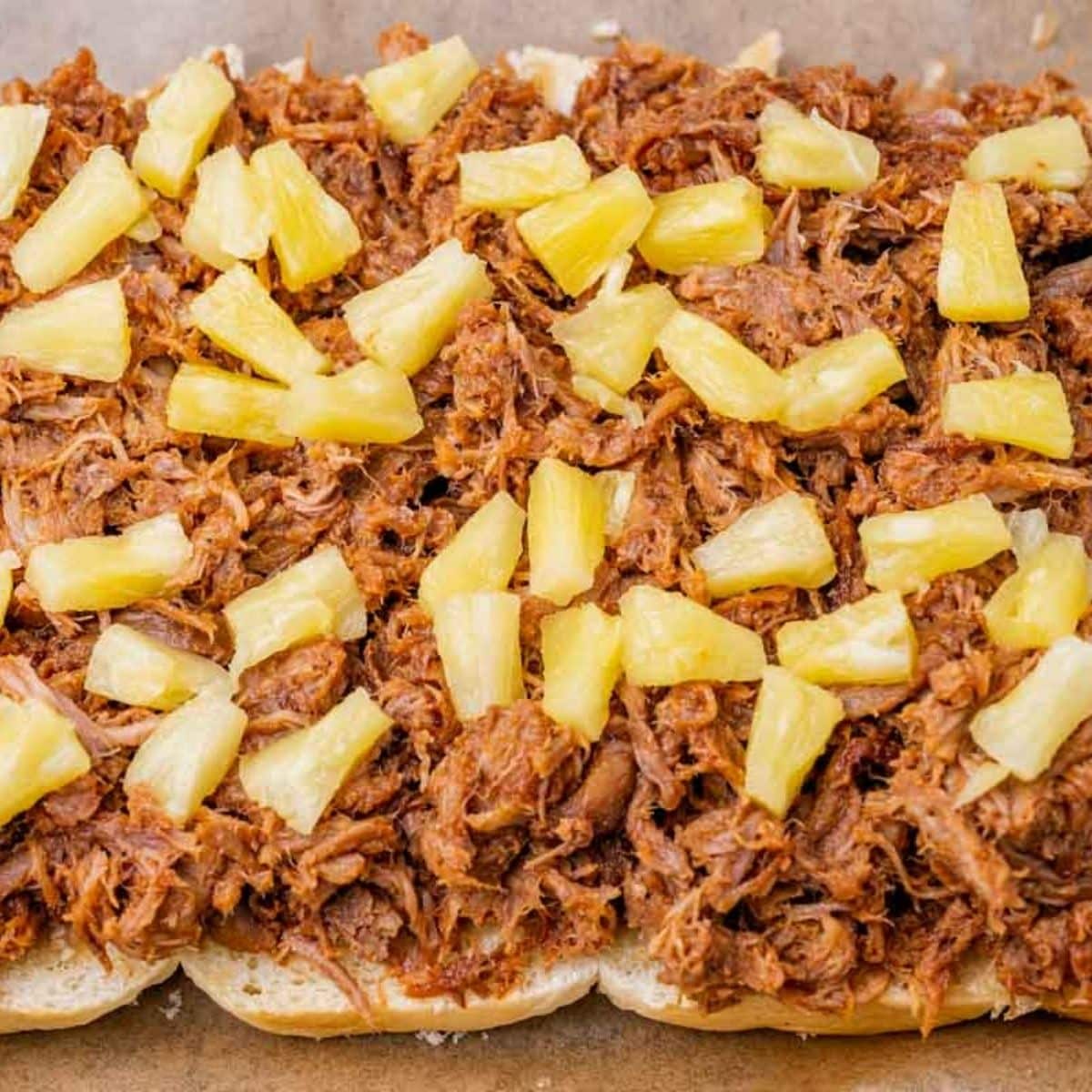 pineapple tidbits on pulled pork for sliders
