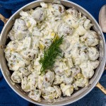 overhead view of creamy dill pickle potato salad in a pan