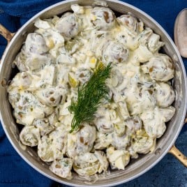 overhead view of creamy dill pickle potato salad in a pan