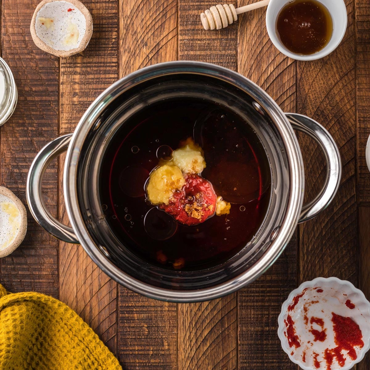 ingredients for honey sesame sauce in a pot