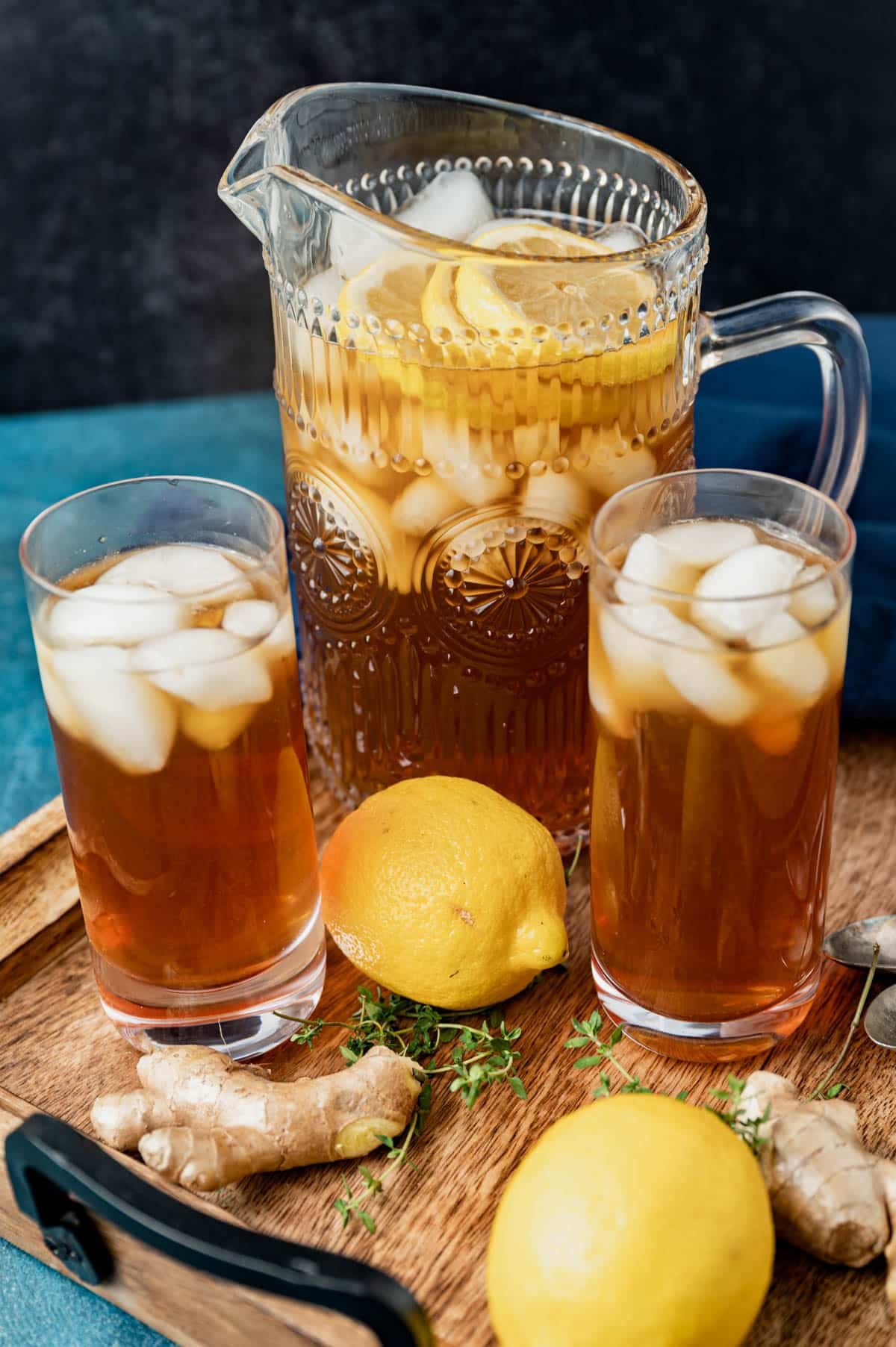 lemon ginger iced tea in a pitcher and two glasses
