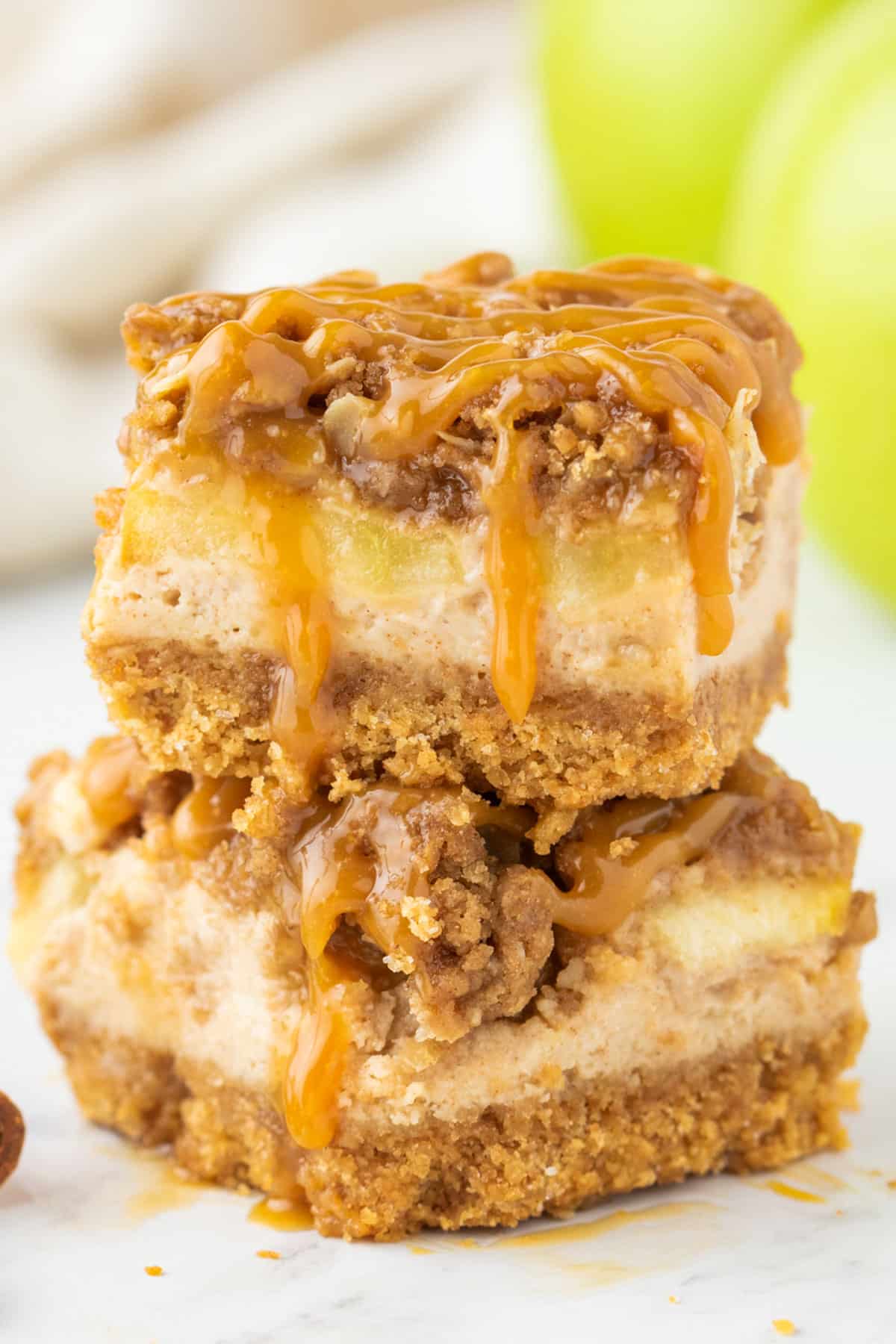 two caramel apple cheesecake bars stacked on each other