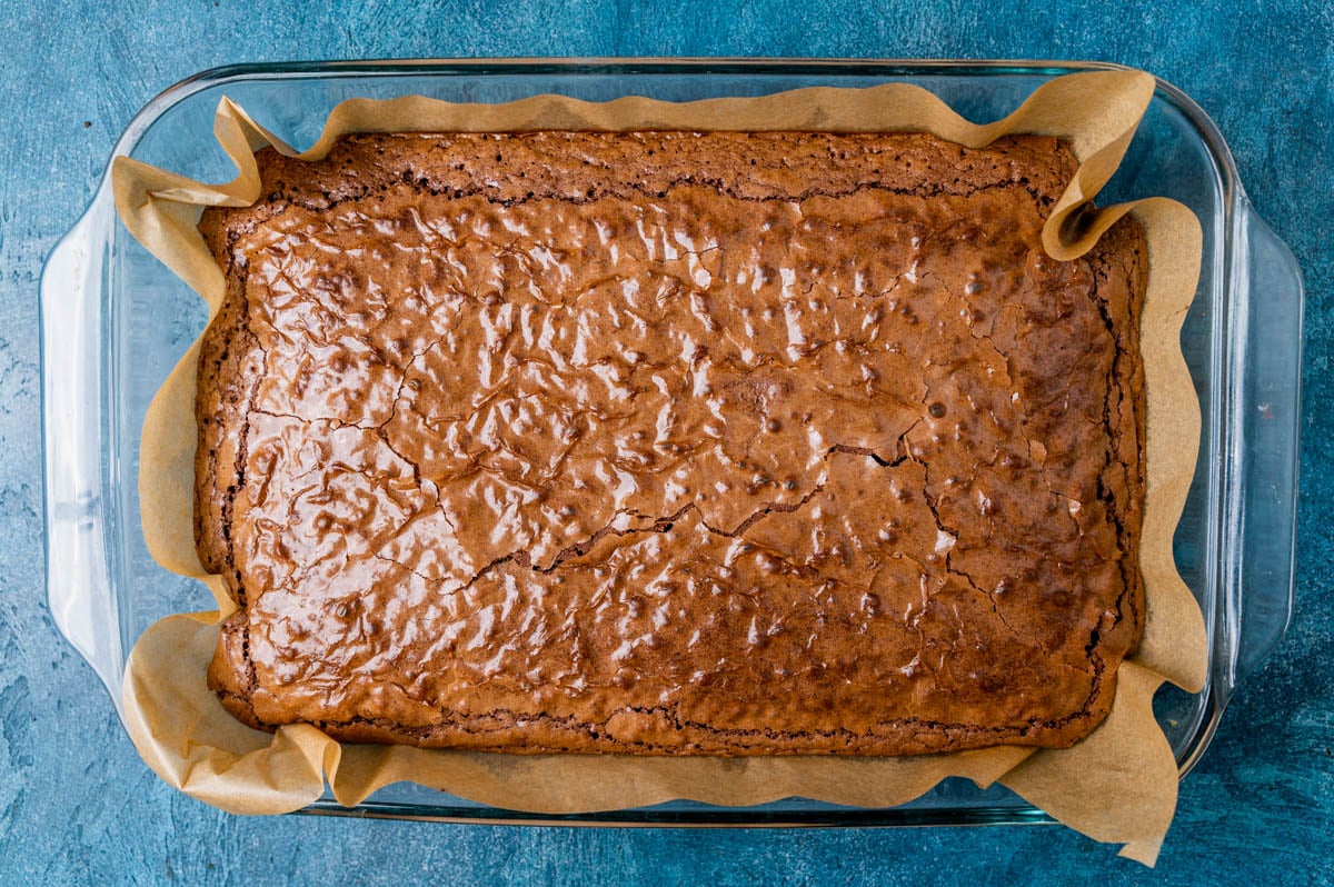 cake like brownies in a glass pan with parchment