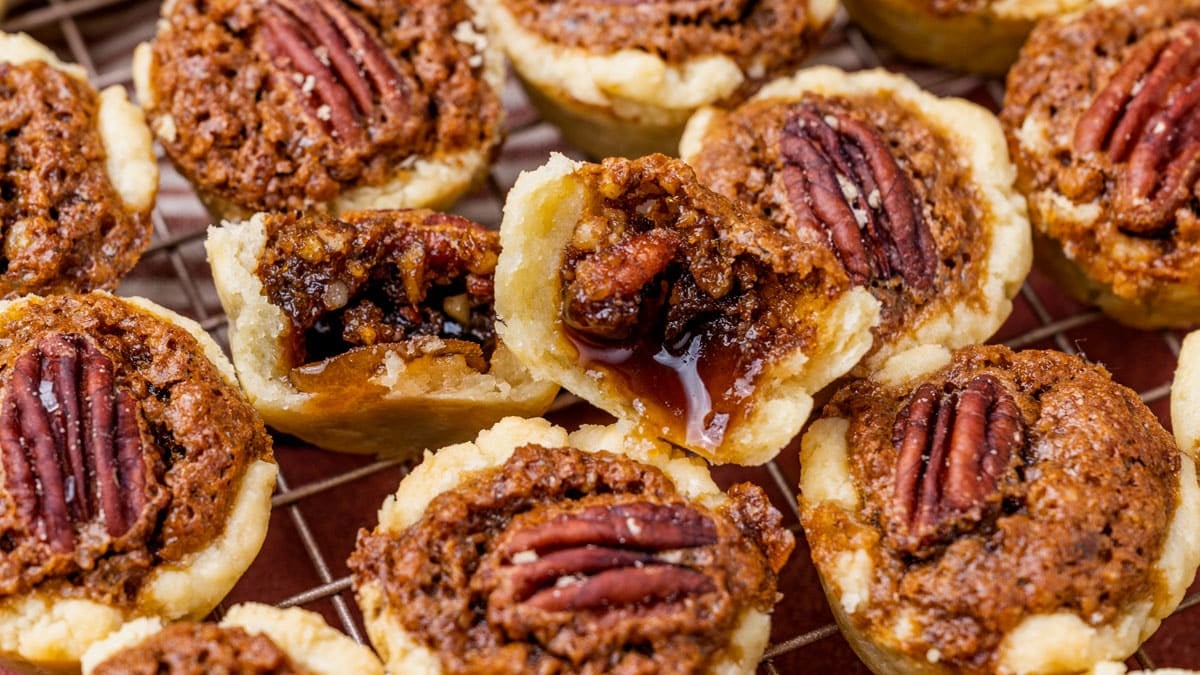 closeup of pecan tassie cookies, one cut in half