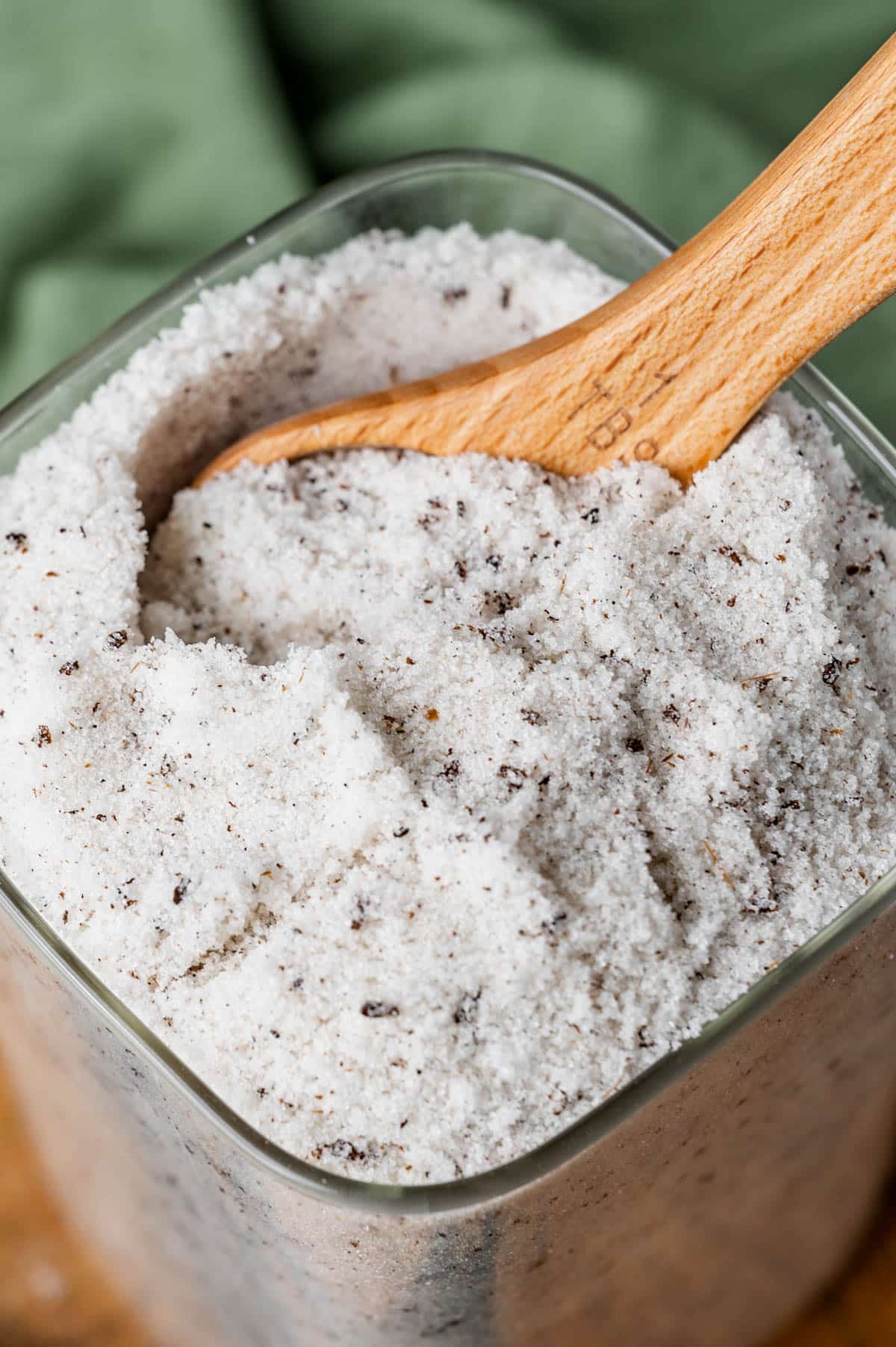a container of vanilla sugar with a wooden spoon in it