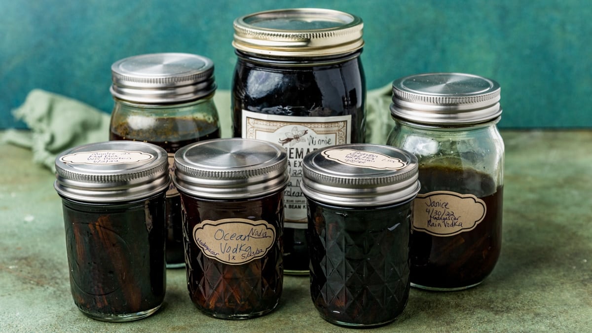 mason jars of different sizes full of vanilla extract