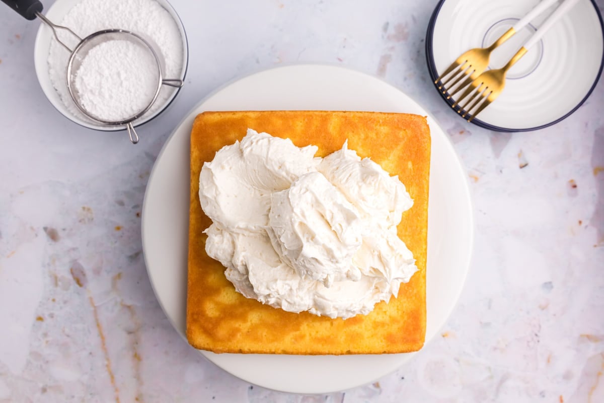 frosting piled on top of a square yellow cake