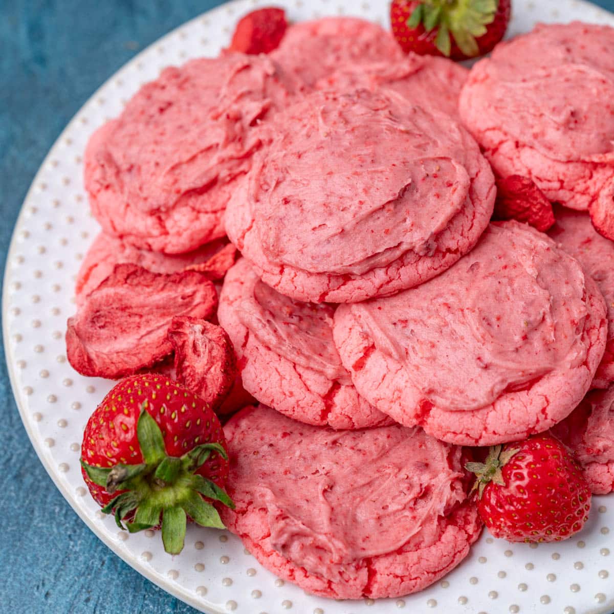 a plate of frosted strawberry cookies
