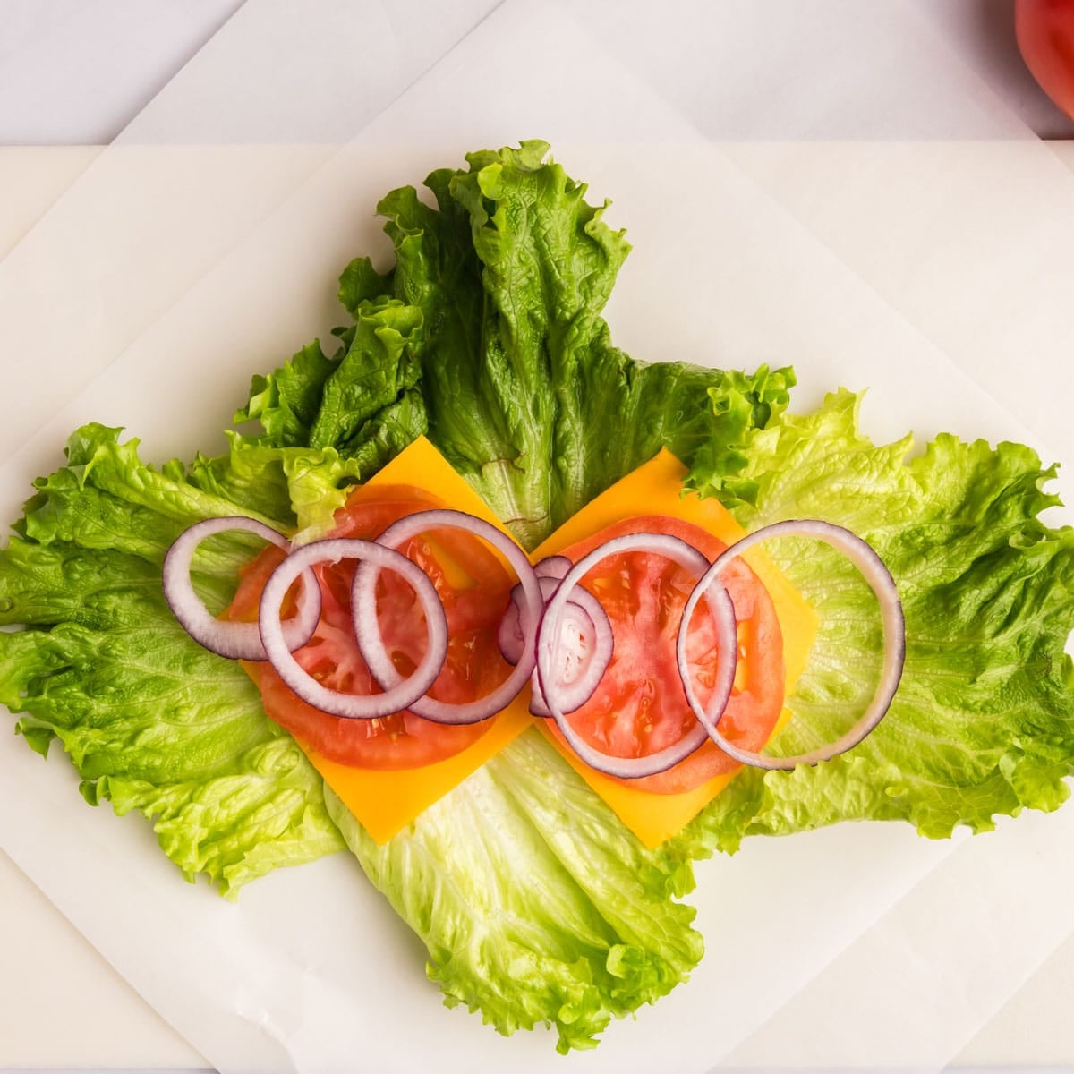 lettuce layered with cheese, tomato and onion