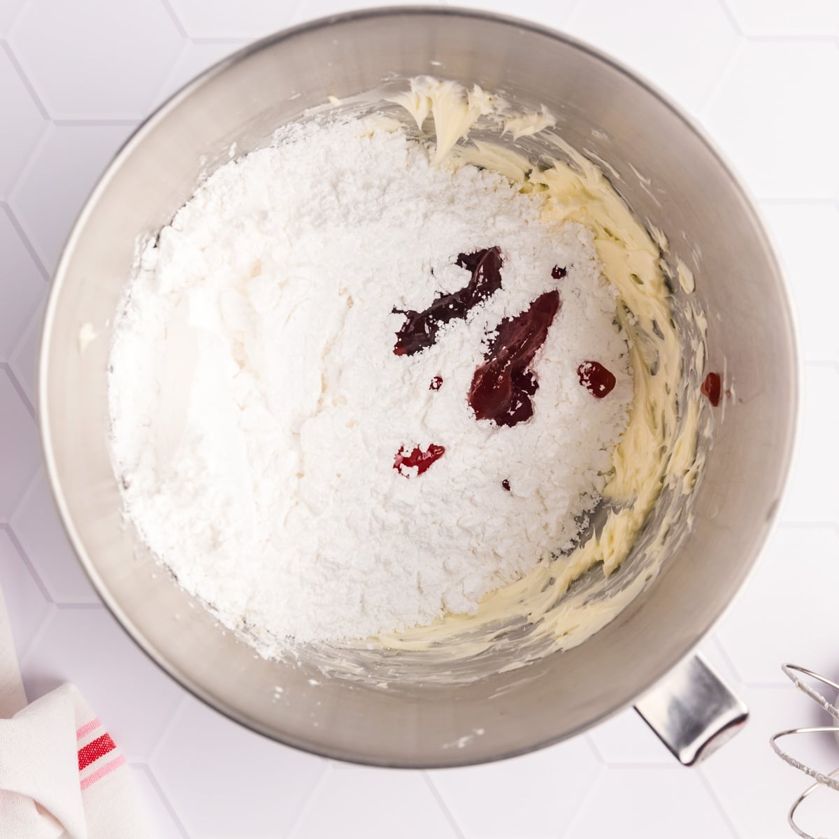 creamed butter with sugar and strawberry jam in a bowl